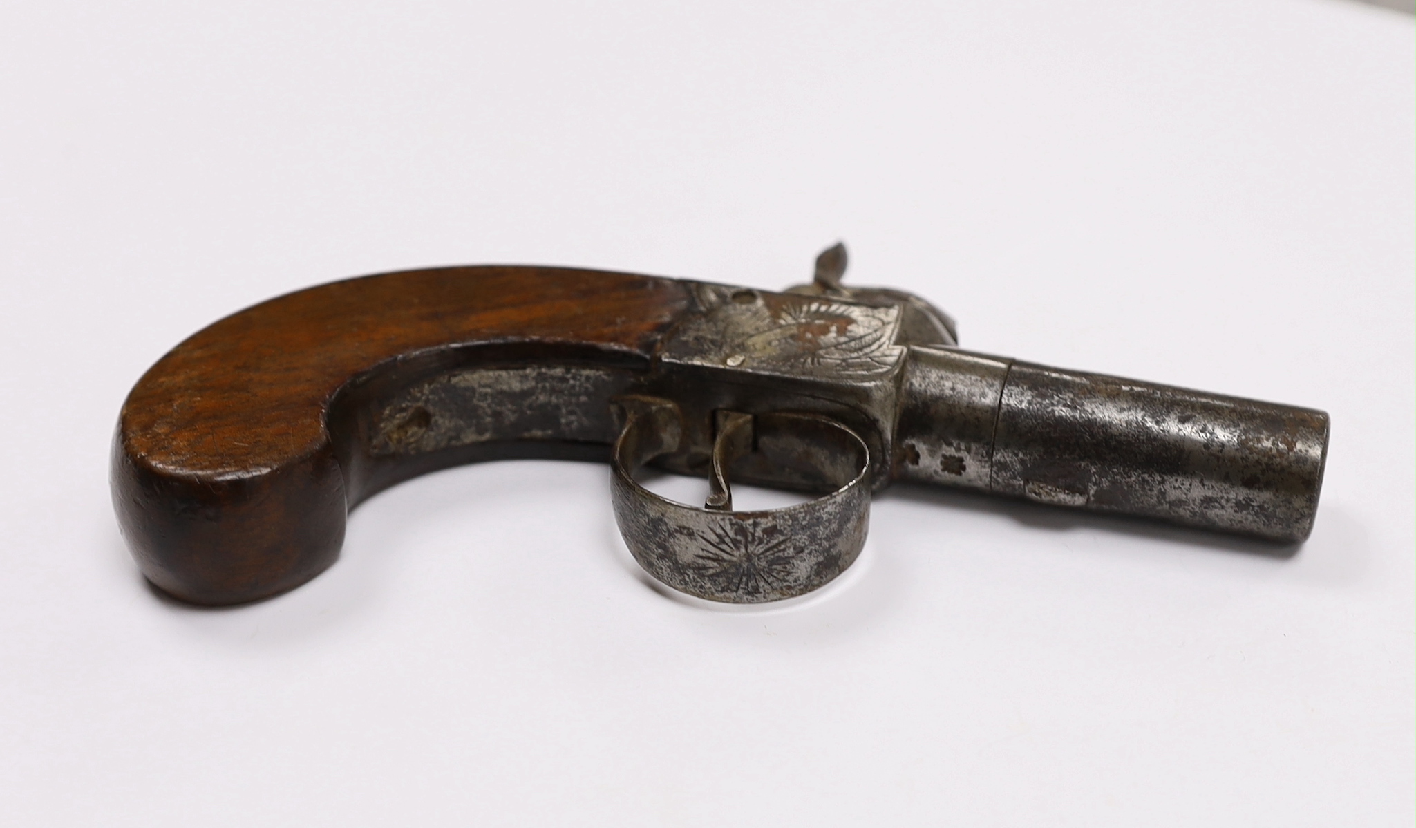 A 19th century box lock percussion pocket pistol with turn off barrel, engraved frame slab and walnut grip, barrel 4.2cm